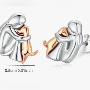 Girl hugging dog Sterling Silver. Measures 1/3 of an inch. Sells for $15